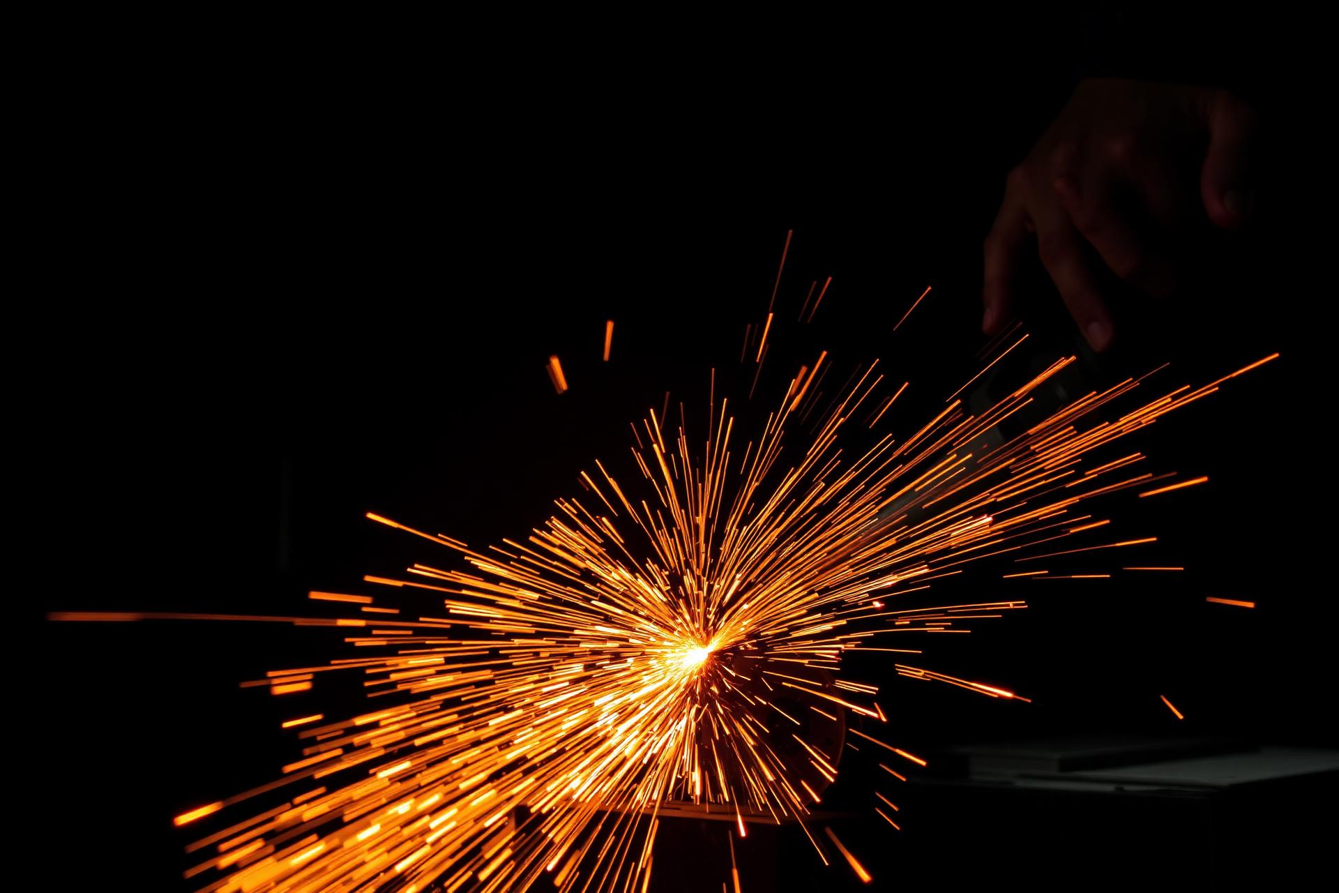 Sparks flying from steel being cut in a fabrication shop